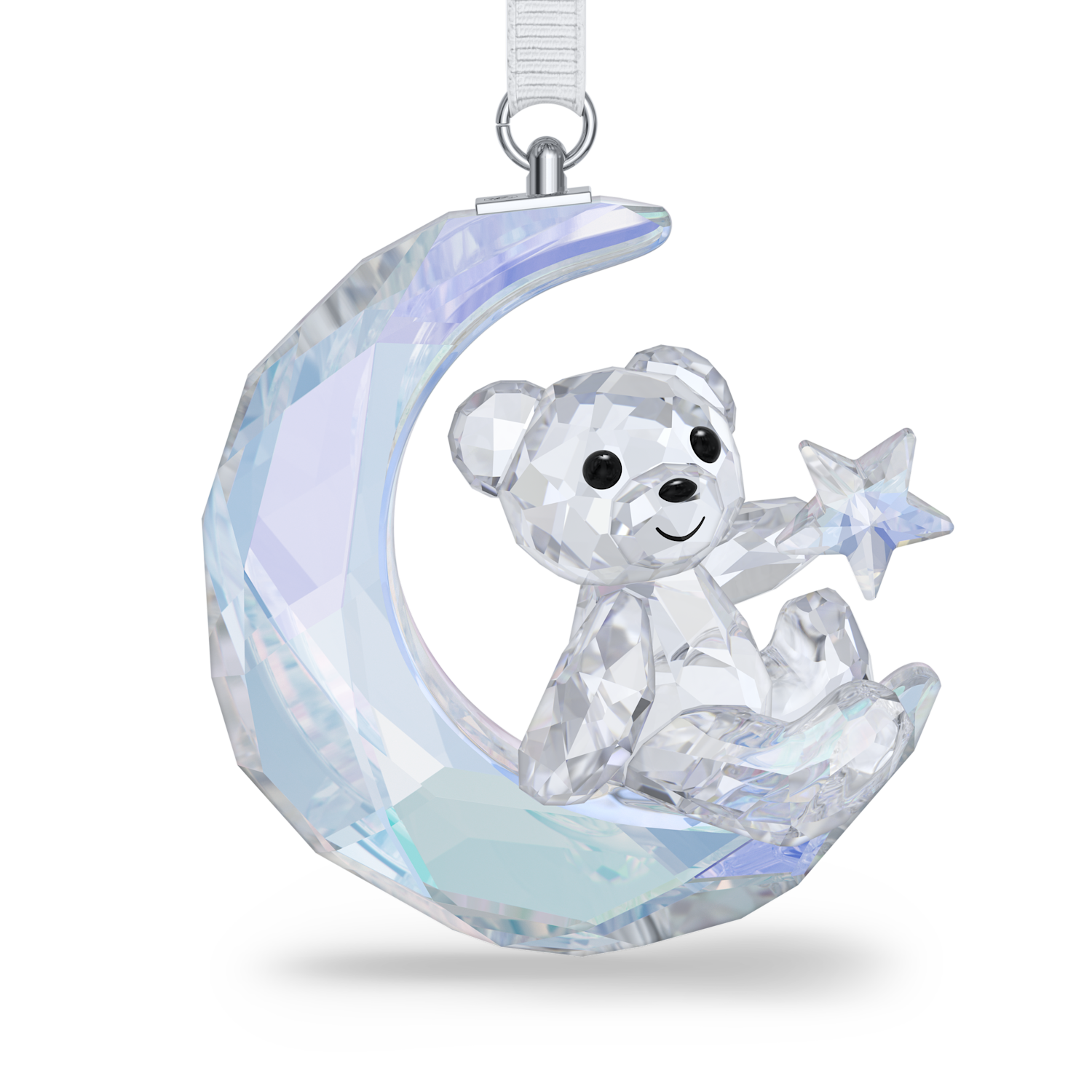 A faceted crystal teddy bear ornament sitting on a crescent moon and holding a star, suspended by a white ribbon with a silver loop, shown on a clean white background.