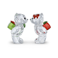 Two clear faceted crystal bear figurines facing each other on a white background. One bear wears a red bow and carries a green gift box, and the other carries a red gift box.