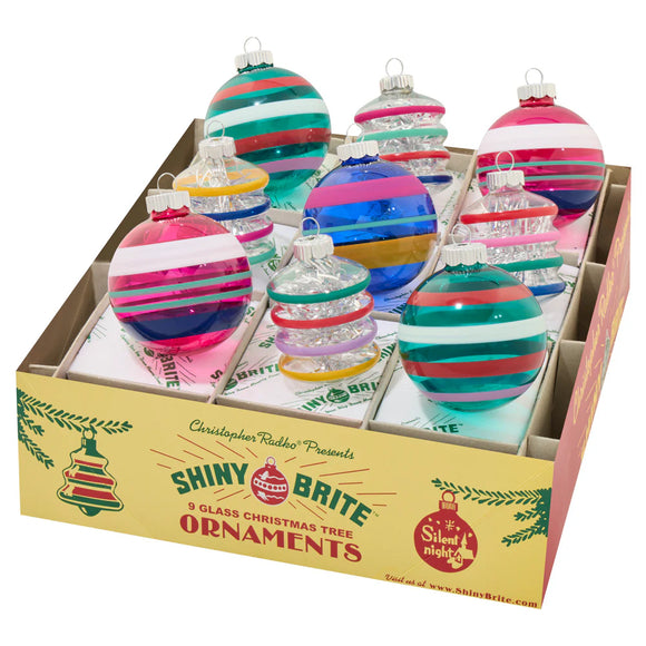 Box of Shiny Brite glass Christmas tree ornaments with colorful striped design.