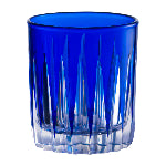 Blue glass tumbler with textured design on a white background