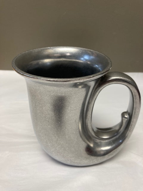 Metallic cup with a handle on a white background