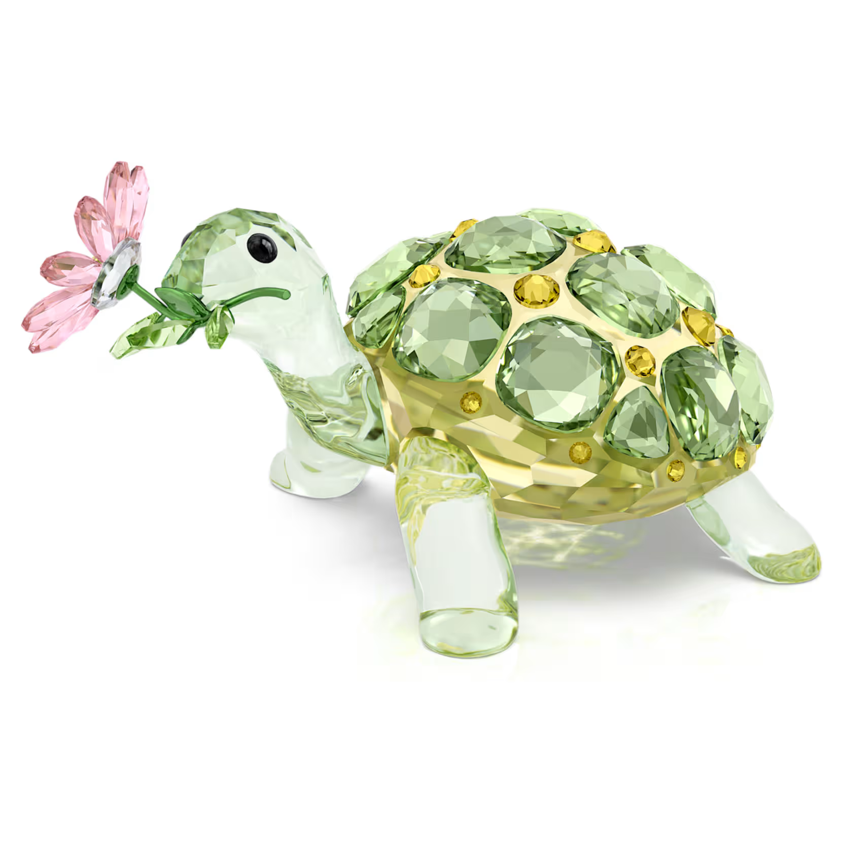 Decorative turtle figurine with gemstone shell on a white background